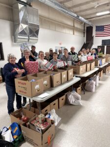 volunteers lined up with boxes and gifts