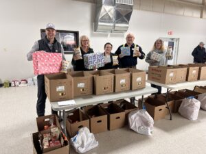 Didion volunteers at organizing event prior to gift and food distribution