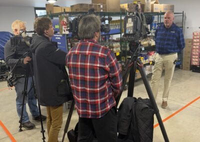 Didion representative being interviewed by local news media about Didion's donation of corn grits