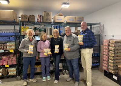 Didion representatives pose with Second Harvest representative and Extended Hands pantry representatives with bags of Didion corn grits