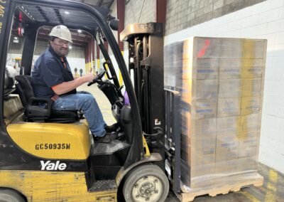 Didion employee loading pallets of corn grits onto Second Harvest delivery truck